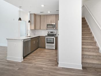 an empty kitchen with a staircase in a house